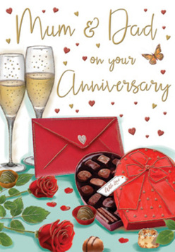 The anniversary card artwork creates a luxurious yet homely still life, perfectly suited to the quiet elegance of Cobham. In the foreground, two full red roses lie across a tabletop, their petals lavish and soft, structured in layers that fold into one another like small silken ruffles. Each rose is framed with a few sprigs of deep green foliage, the leaves smooth and slightly glossy, emphasising the freshness and quality a seasoned florist would choose for an anniversary gift. Just in front, a heart-shaped chocolate box becomes the focal point. Its rich red surface has a soft sheen, and its lid is tipped back to reveal rows of chocolate treats, each one distinct in shape and nestled in softly crinkled gold paper cups. A generous satin ribbon in matching red wraps around the box, the bow voluminous and confidently tied, conveying a sense of occasion. Behind this inviting arrangement, two tall champagne flutes stand close together, their clear glass reflecting tiny highlights of light. They hold a delicate golden champagne, where fine bubbles dance upward, ready for a toast that might be raised in a Cobham home overlooking the river or after a gentle walk through Painshill's landscaped grounds. Scattered across the upper part of the card are tiny hearts in shades of crimson and metallic gold, drifting around flowing script that addresses loving wishes to Mum and Dad. To one side, a bright red envelope lies at an angle, its neat point and smooth surface suggesting a lovingly written message waiting to be opened. The whole composition is bathed in a warm, soft glow, echoing the feeling of an intimate family celebration marked by roses, chocolate, champagne, and years of shared memories.