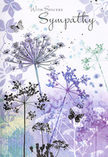 Within this sympathy card, the illustration unfolds like a gentle poem written in colour and line, inspired by the calm landscapes around Cobham. The background is a flowing blend of pale lavender, clouded mauve, and powdery blue, with faint touches of green that hint at a distant meadow or riverbank. Rising from the lower edge, slender stems climb skyward, each tipped with a cluster of umbelliferous flowers drawn in the lightest of strokes. The blooms resemble tiny, lace-like fireworks frozen mid-burst, their outermost points fading into the surrounding wash so that they seem to hover in the air, delicate yet enduring. These floral silhouettes recall the kind of wild seed heads you might notice beside the paths near Painshill Park, quietly holding their shape through changing seasons. Around them, butterflies drift with barely-there outlines, wings washed in translucent shades of violet and cool blue that echo the sky-like tones behind them. They appear to be moving gently through the scene, suggesting the idea of souls at peace or comforting presences staying close in times of sorrow. The light across the card is even and soft, with no defined source, creating an atmosphere of hush and reflection-more like a memory than a literal landscape. The overall palette is cool but not cold, offering reassurance rather than brightness, like a soft-spoken conversation on a quiet lane. Near the top of the design, the words With Sincere Sympathy (or an equally gentle phrase) are written in elegant, flowing script, carefully placed so as not to crowd the artwork. Crafted with the same thoughtfulness we bring to arranging condolence flowers at Flower Delivery Cobham, this card's design offers a respectful, understated way to express deep sympathy and support.